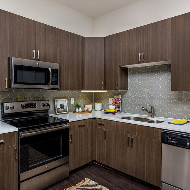 Creekside at Crabtree - Kitchen with Stylish Wood Shelves and Modern Appliances